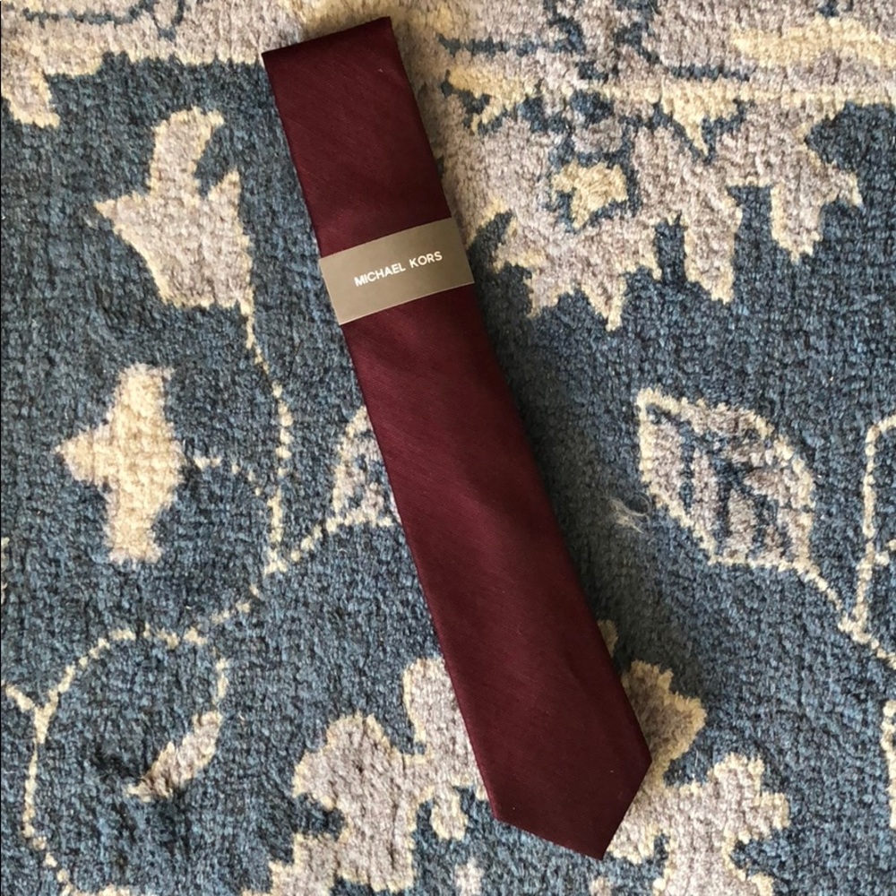 Michael Kors tie is maroon with navy backing